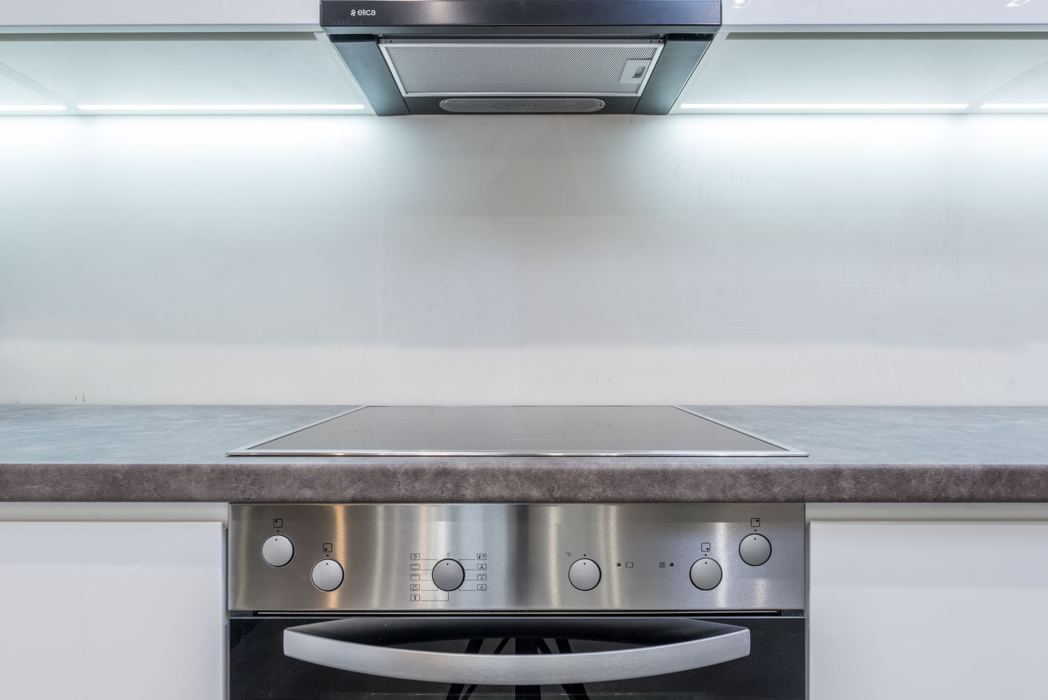 A sleek, modern kitchen with steel appliances and minimalist design.